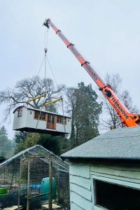 ac45 mobile crane lifting a shepherds hut